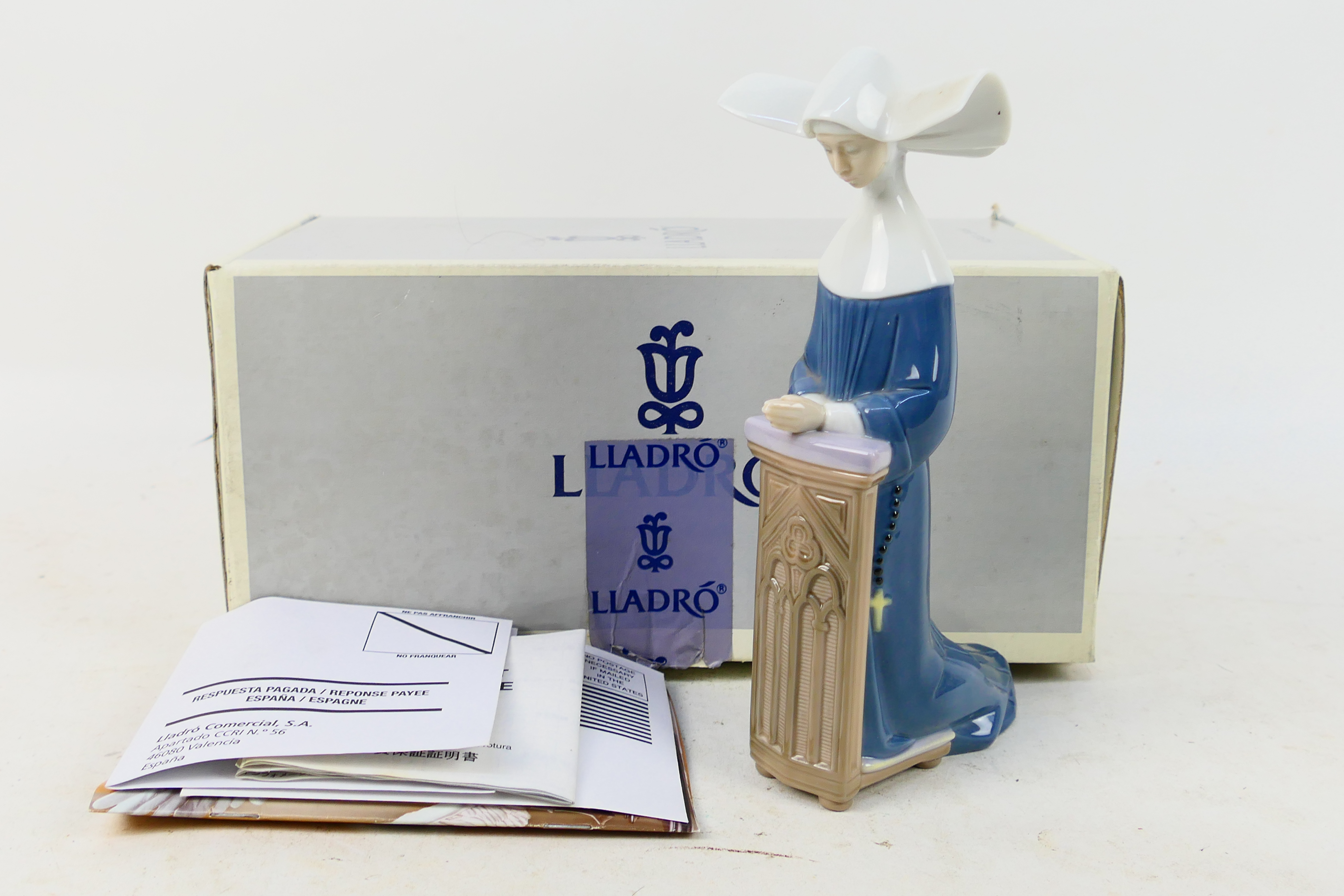 A boxed Lladro figure depiction a prayin