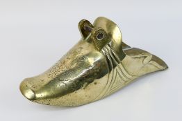 A silver plated gaucho stirrup with engr