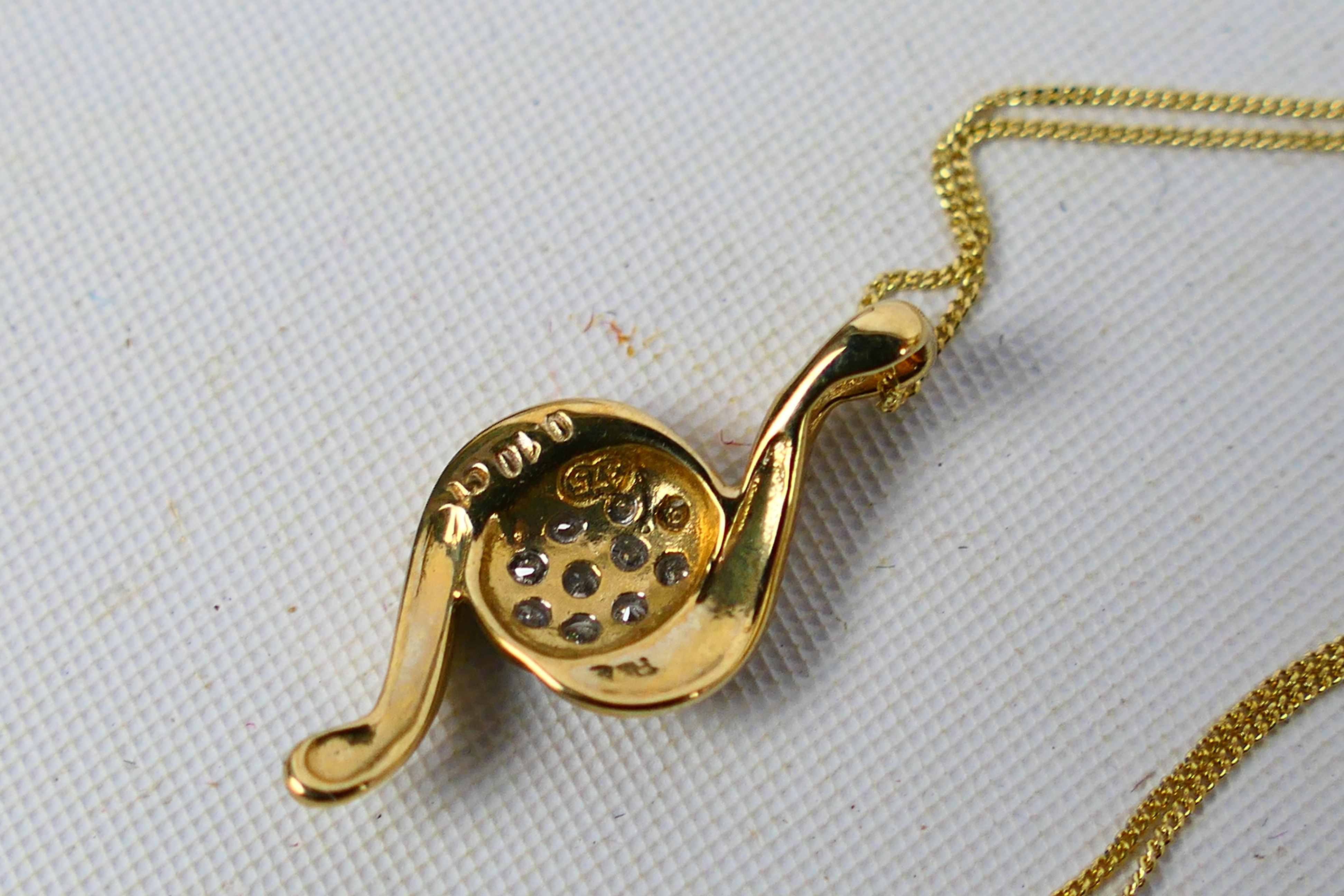 A yellow metal (stamped 375) diamond set pendant on yellow metal fine trace chain stamped 375, - Image 3 of 3