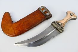 A late 19th or early 20th century white metal mounted jambiya dagger,