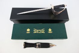 A boxed Wilkinson Sword sgian dubh and a boxed miniature sword.