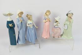 A collection of Lladro and Nao figures, largest approximately 28 cm (h).