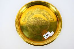 A circular pressed brass tray inscribed for The Royal Tank Corps, 21 cm (d).