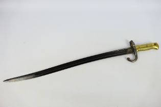 A French M. 1866 bayonet, 57 cm (l) blade, approximately 69 cm (l) overall.