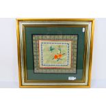 A Chinese embroidery on silk depicting flowers and a butterfly, framed under glass,