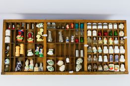 A printers vintage letterpress drawer containing a collection of salt and pepper cruets, ceramic,