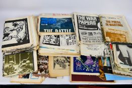 A vintage suitcase containing a large quantity of royal and war related ephemera.