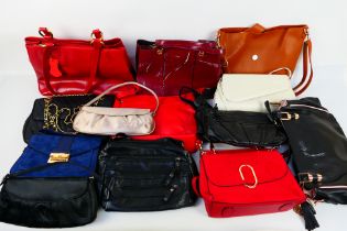 A job lot of predominantly unmarked handbags to include colours of dark blue, dark red, black,