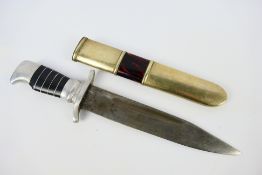 A World War Two alloy hilt fighting knife with 17 cm (l) blade and S shaped crossguard,