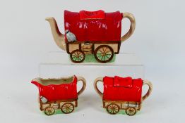 A Sadler novelty three piece tea set comprising teapot, sugar bowl with cover and milk jug,