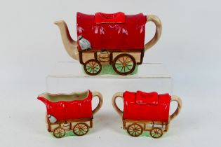 A Sadler novelty three piece tea set comprising teapot, sugar bowl with cover and milk jug,