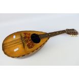 A vintage eight string, bowl back mandolin.