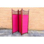 A three fold wood and upholstered screen / room divider, each panel approximately 195 cm x 61 cm.