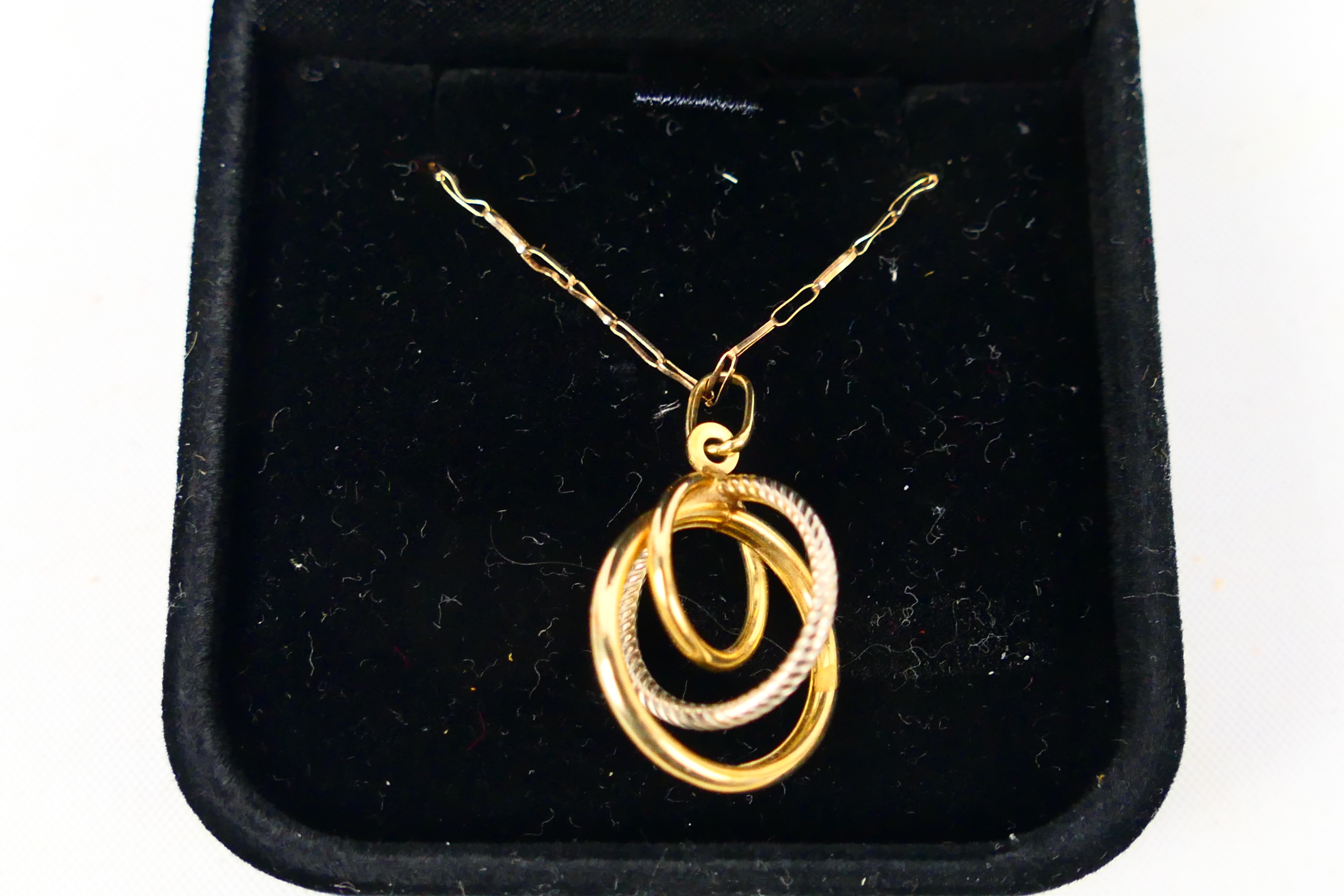 A 9ct yellow gold necklace, 56 cm (l), with pendant stamped 375, approximately 1.7 grams.