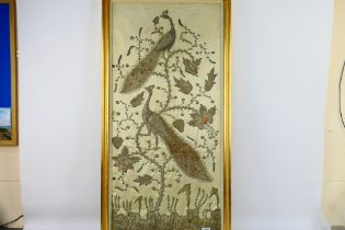 A framed embroidery depicting perching peacocks , approximately 86 cm x 45 cm.
