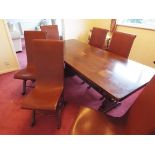 A refectory dining table and six dining chairs with brown leather upholstery,