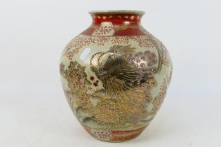 An Oriental crackle glaze vase of ovoid form with gilt decoration of a peacock amidst foliage,