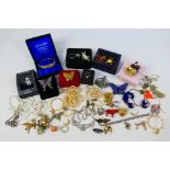 A collection of costume jewellery to include silver bangle, brooches, rings and similar.