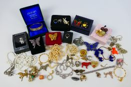 A collection of costume jewellery to include silver bangle, brooches, rings and similar.