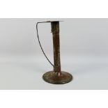 An Arts And Crafts style copper and brass candlestick, remnants of plating in areas,