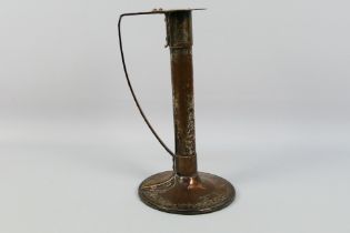 An Arts And Crafts style copper and brass candlestick, remnants of plating in areas,