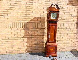 An interesting 8-day brass dial longcase clock,