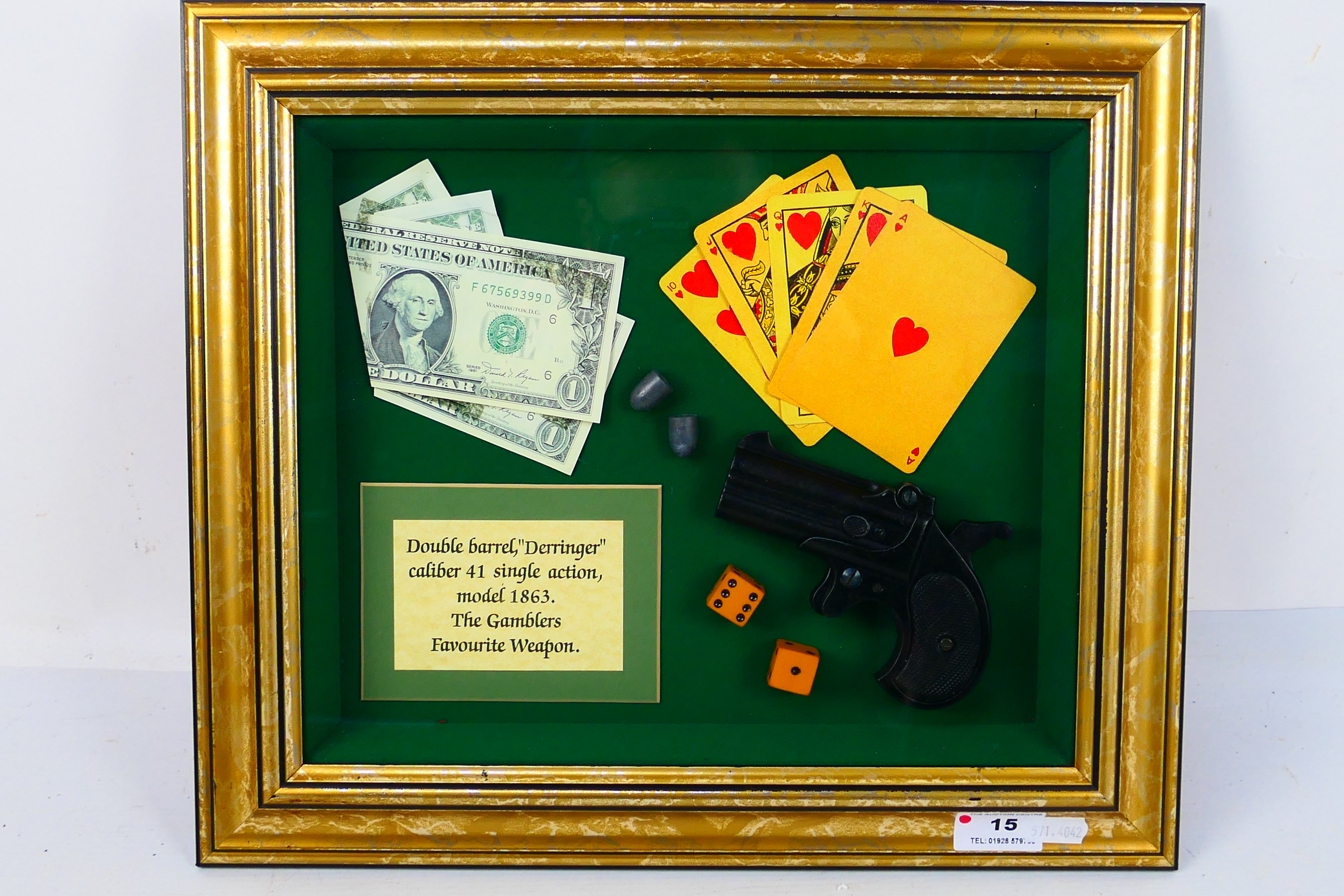 A framed display of a reproduction Derringer .