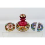 Three unmarked glass millefiori paperweights. Lot includes a scent bottle with lid.