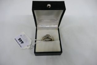 A white metal ring (assessed as 9ct) set with twelve small diamonds, size P, approximately 7.