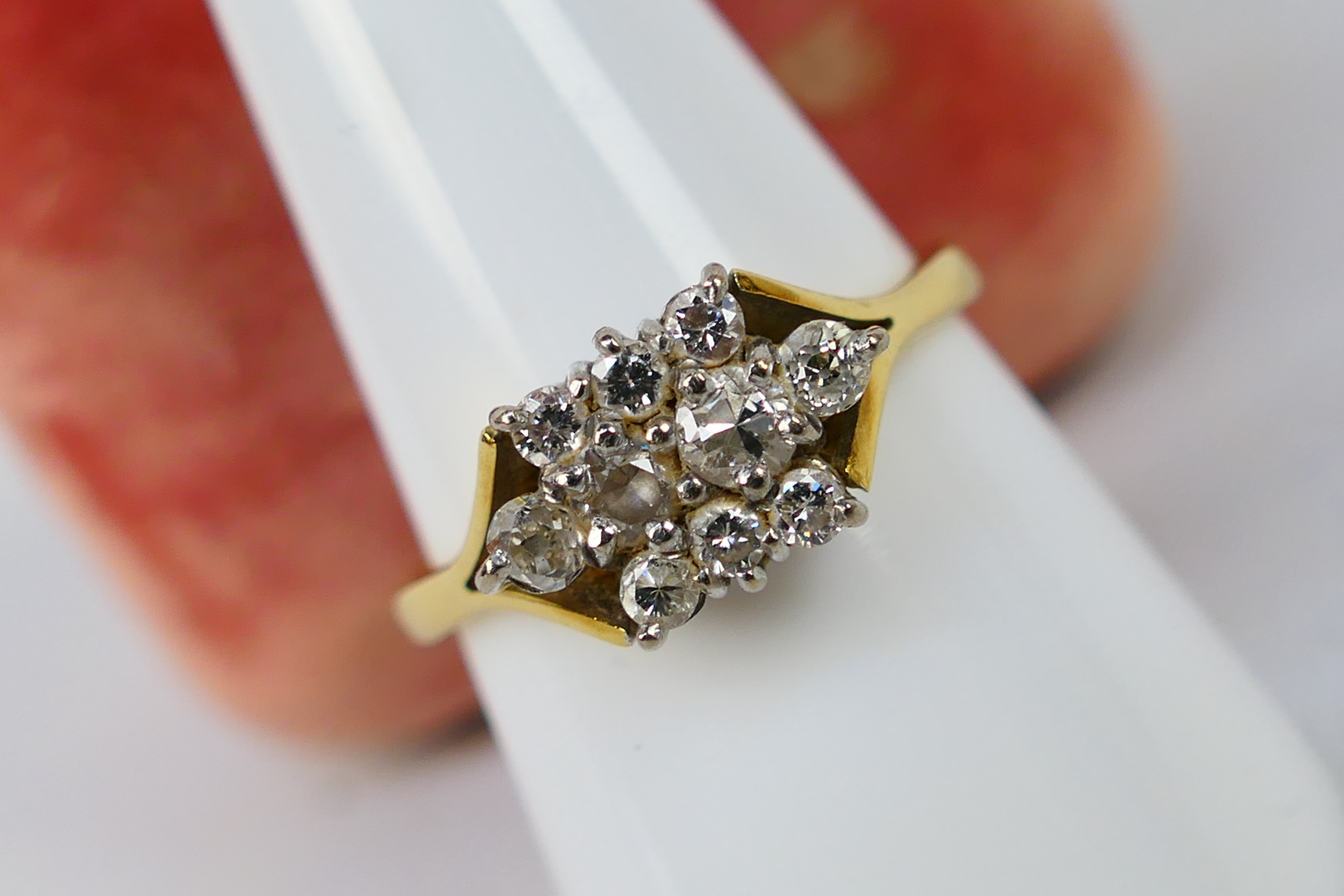 A gold and diamond cluster ring centrally set with four old cut diamonds,