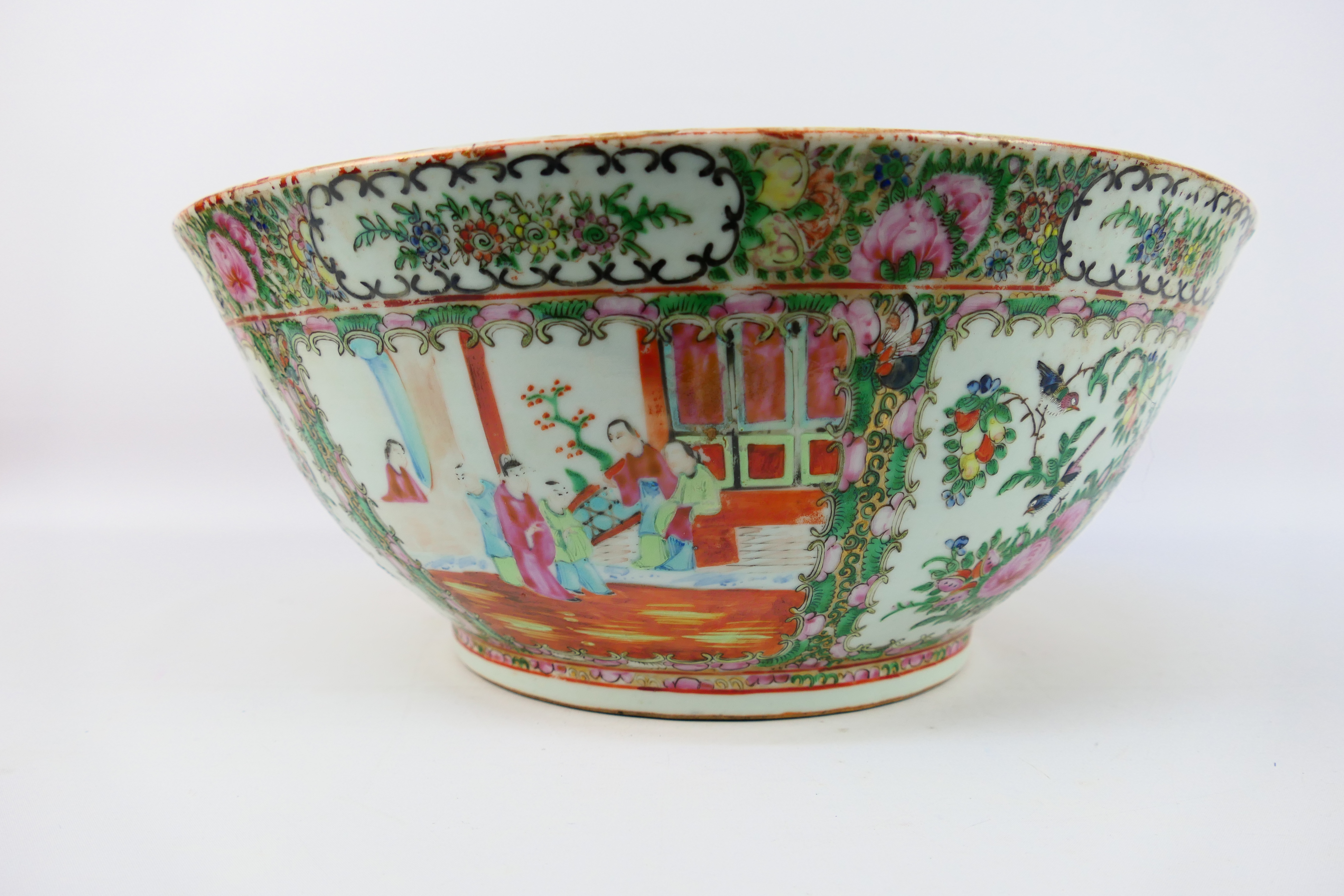 A large Cantonese famille rose punch bowl, typically decorated with panels of figures and flora, - Image 3 of 9