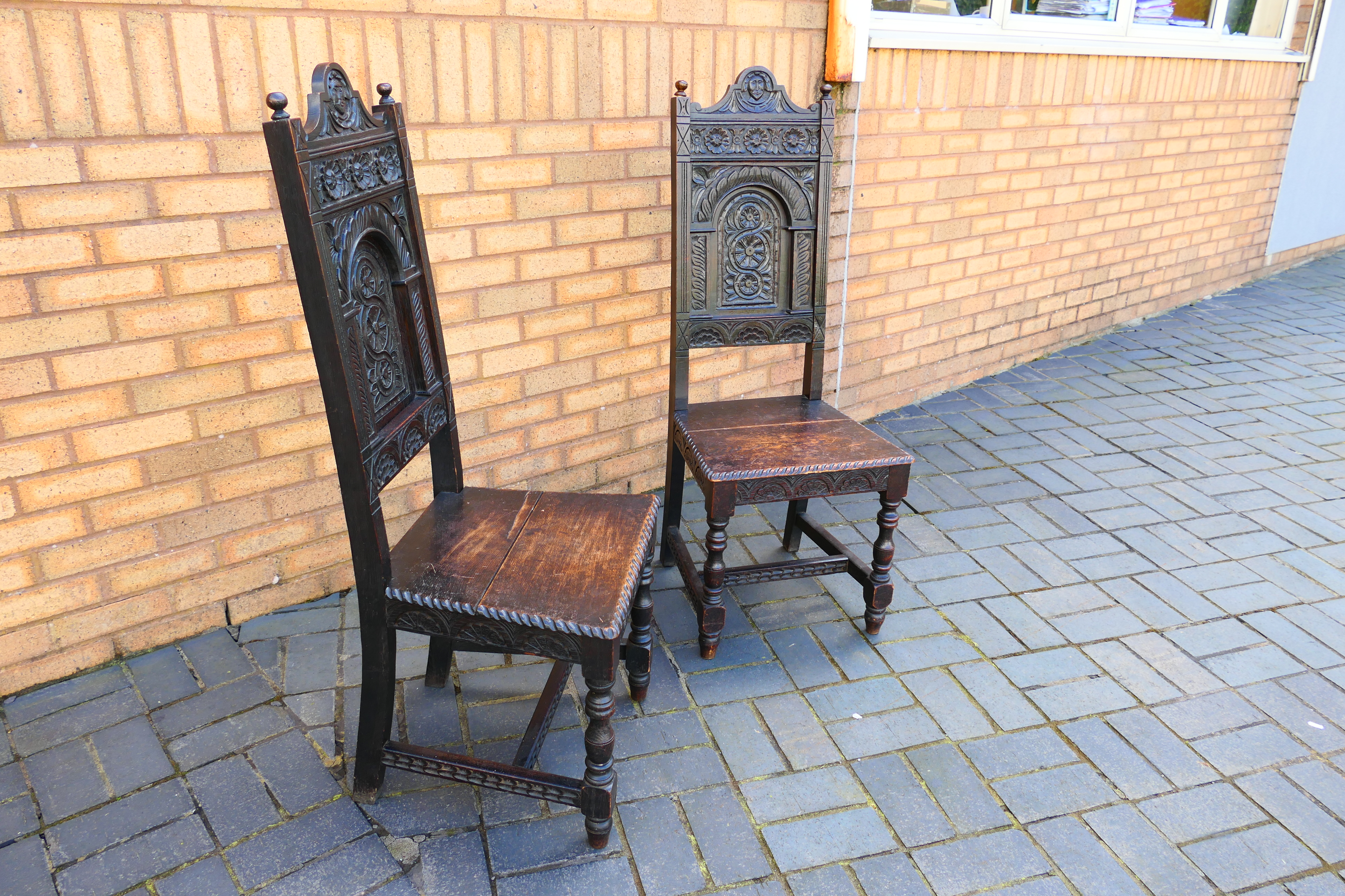 An antique pair of highly carved oak hall chairs. [2]. - Image 5 of 6