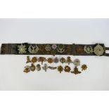 A collection of cap badges and similar insignia to include Royal East Kent, Rifle Brigade,