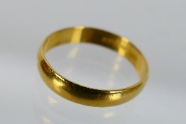 A 22ct gold wedding band, size O, approximately 2.9 grams.