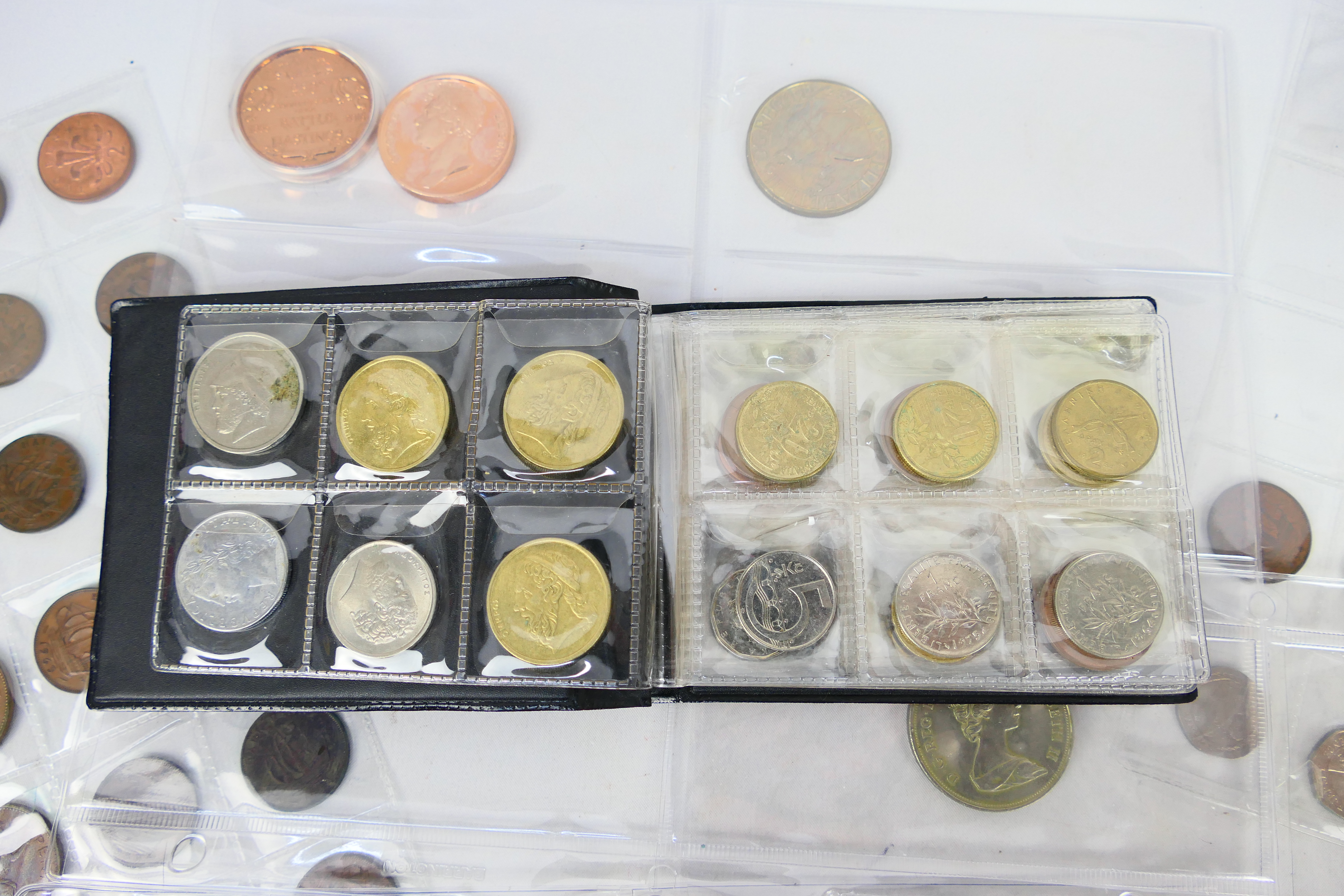 A collection of UK and foreign coins to include collectable fifty pence (50p) examples and other. - Image 7 of 10