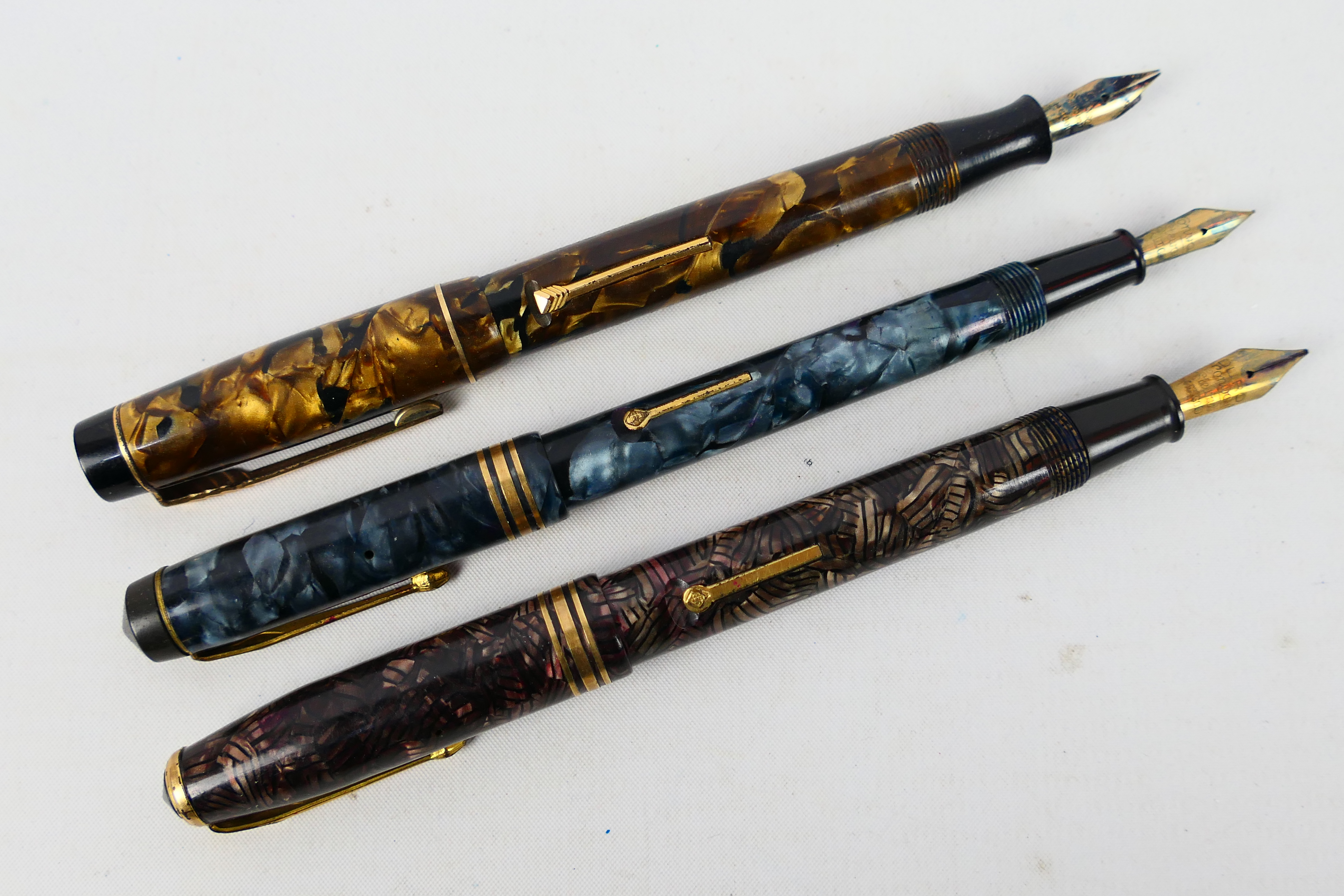 Three vintage fountain pens comprising a Conway Stewart 388, a Conway Stewart 58 and a Croxley Pen,