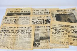 A collection of vintage newspapers with front pages detailing historically significant events to