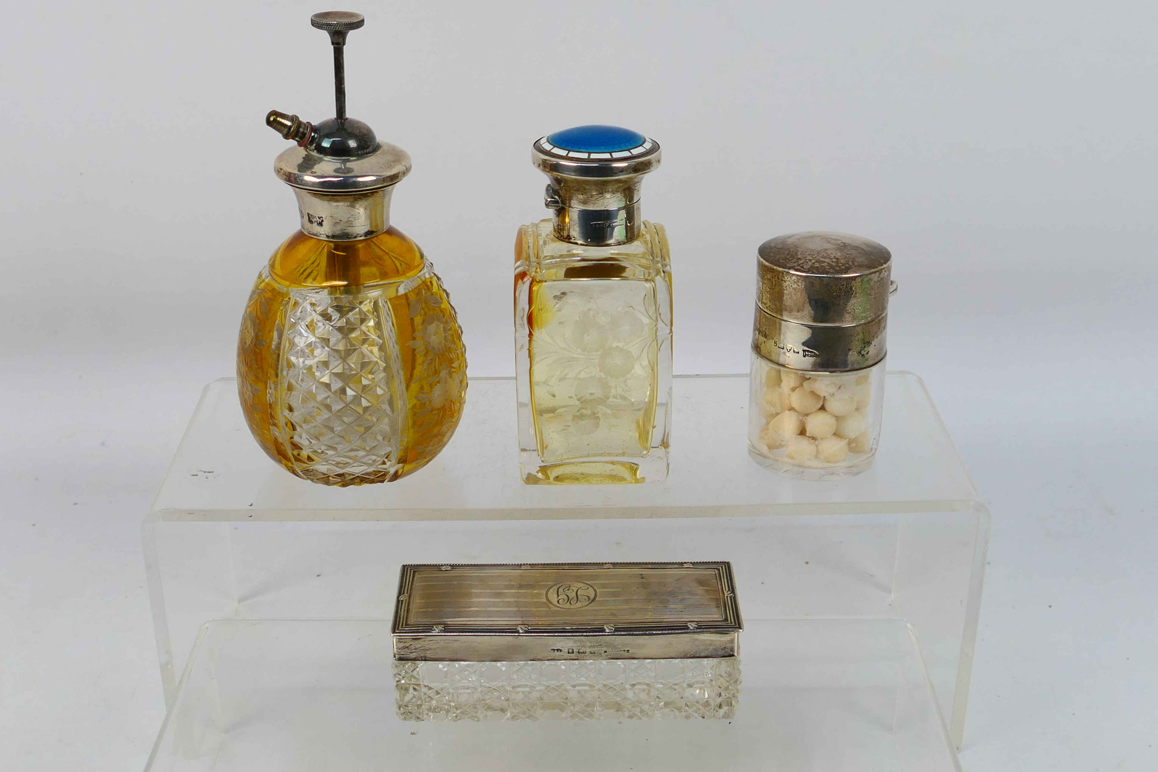 A group of silver mounted dressing table items comprising scent bottle with silver and enamel lid,