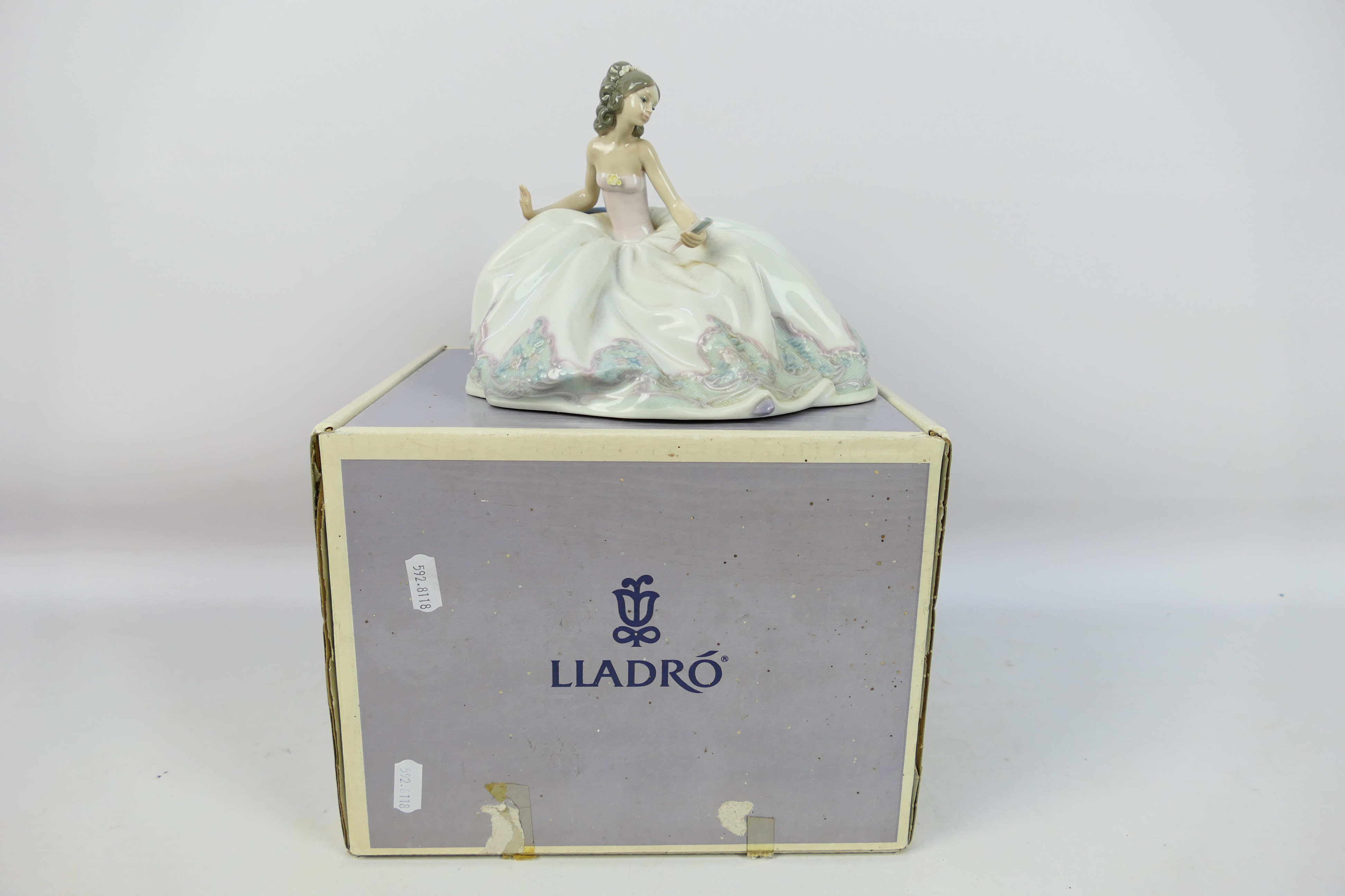 Lladro - A boxed figure entitled At The Ball, # 5859, approximately 15 cm (h).