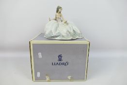 Lladro - A boxed figure entitled At The Ball, # 5859, approximately 15 cm (h).