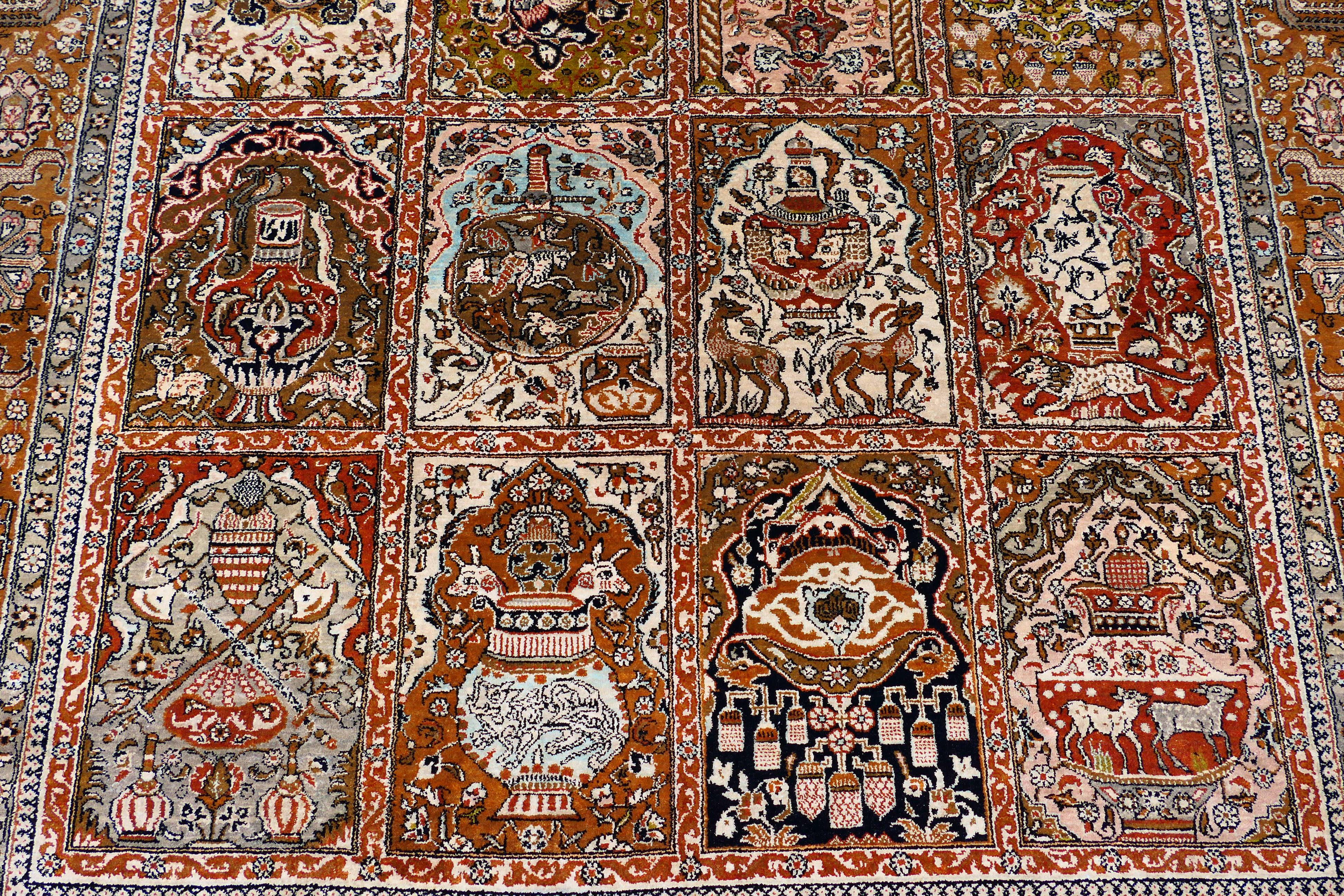 A Persian rug decorated with panels of flowering urns, - Image 14 of 17