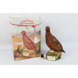 Famous Grouse - A ceramic Royal Doulton grouse form decanter containing 75cl of Famous Grouse