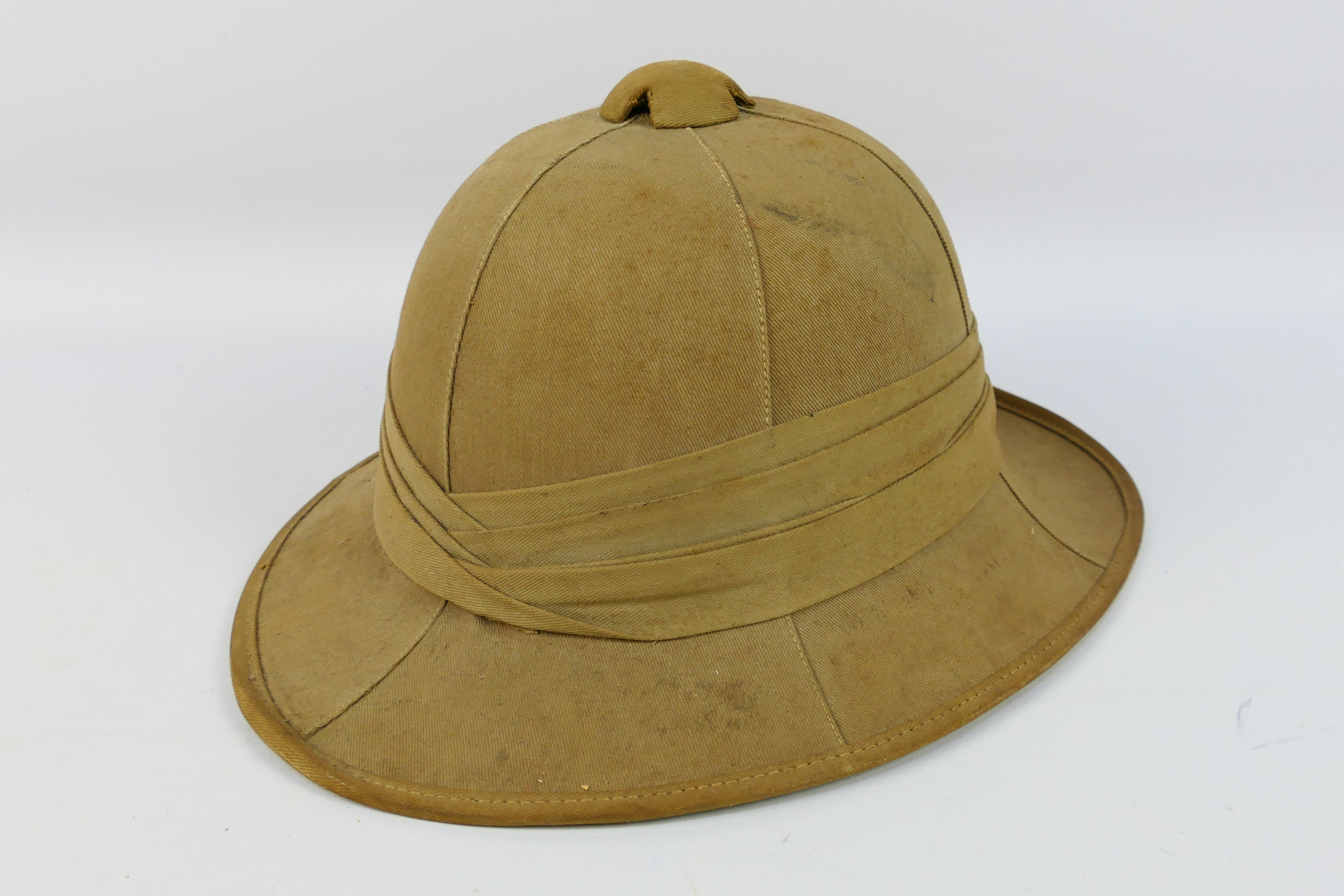 A World War Two (WWII) British Pith Helmet, dated 1942 and maker marked 'Failsworth Hats Ltd'.