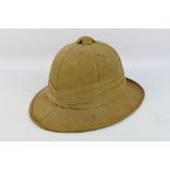A World War Two (WWII) British Pith Helmet, dated 1942 and maker marked 'Failsworth Hats Ltd'.