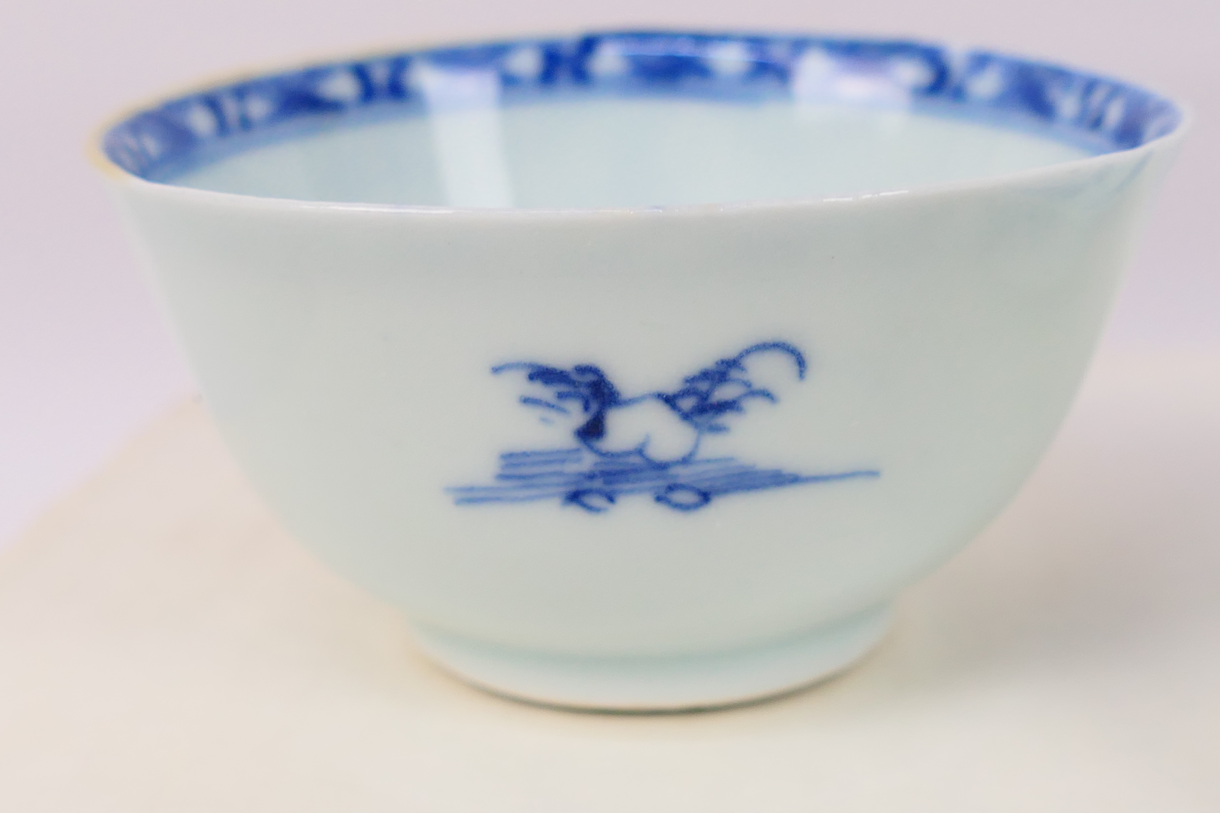 Nanking Cargo - A Qing dynasty blue and white tea bowl and saucer decorated with pine trees, c. - Image 6 of 9