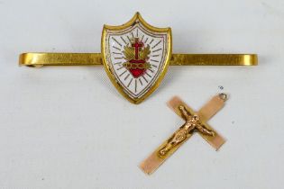 A yellow metal and enamel bar brooch, stamped 9ct and a crucifix pendant also stamped 9ct,
