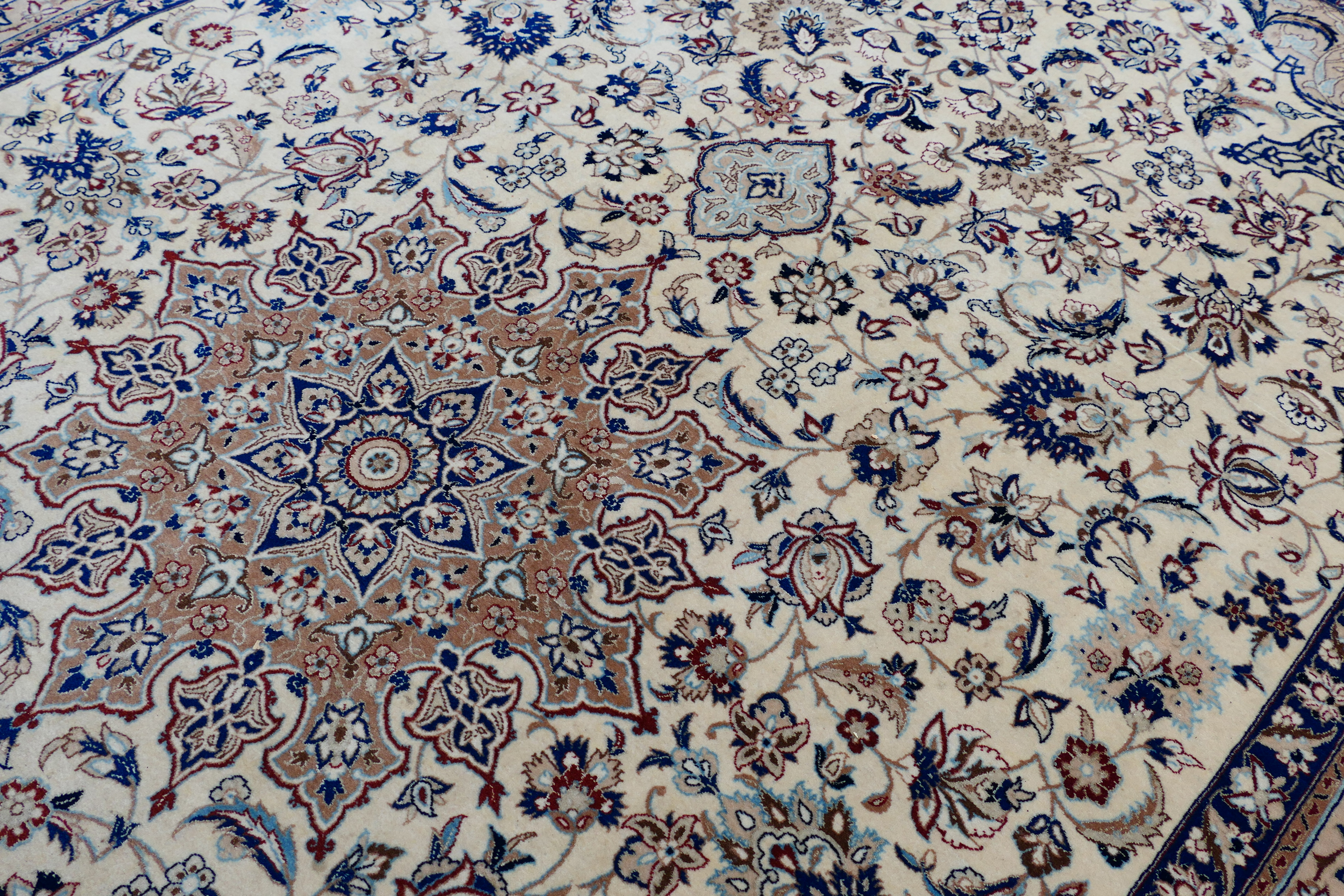 A Persian ivory ground rug with central medallion on a floral field, with foliage scroll border, - Image 14 of 14