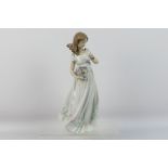 A large Lladro figure # 6921, Treasures Of The Earth, depicting a young lady collecting flowers,