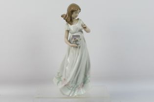 A large Lladro figure # 6921, Treasures Of The Earth, depicting a young lady collecting flowers,