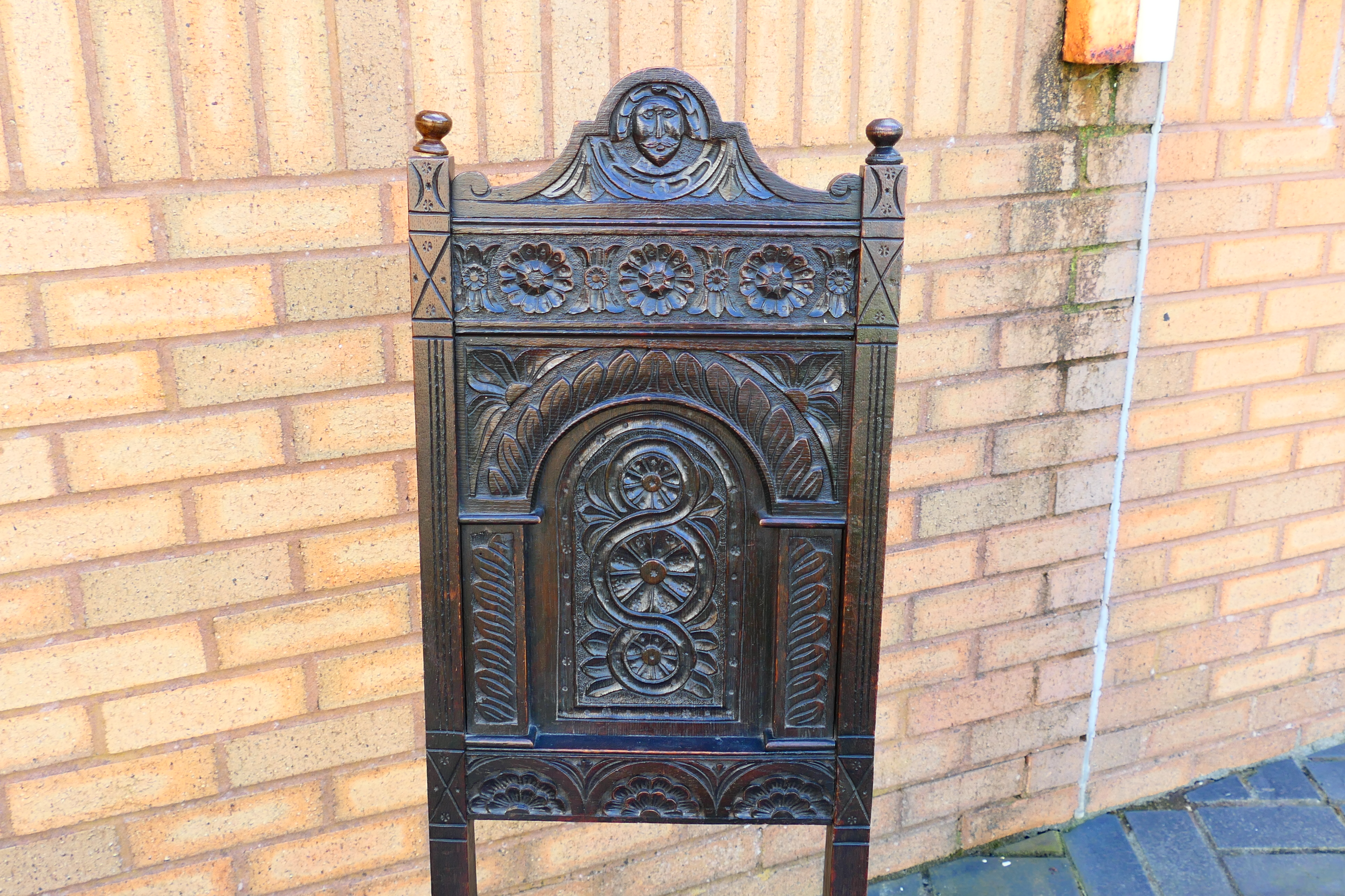 An antique pair of highly carved oak hall chairs. [2]. - Image 4 of 6